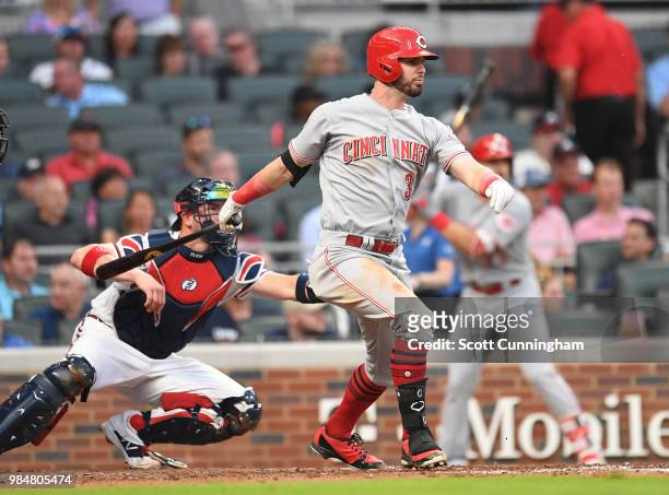 Jesse Winker of the Cincinnati Reds hits a fourth inning double to knock in a run against the Atlanta Braves at SunTrust Park on June 26, 2018 in...