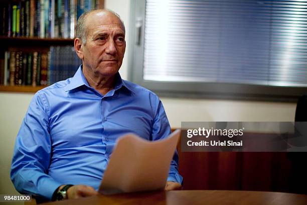 Former Israeli Prime Minister Ehud Olmert poses for photographers after delivering a public statement at his office on April 15, 2010 in Tel Aviv,...