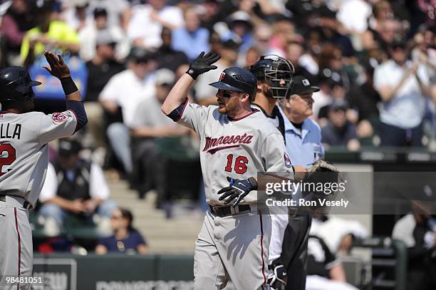 Jason Kubel of the Minnesota Twins celebrates with teammates after hitting a home run against the Chicago White Sox on April 10, 2010 at U.S....