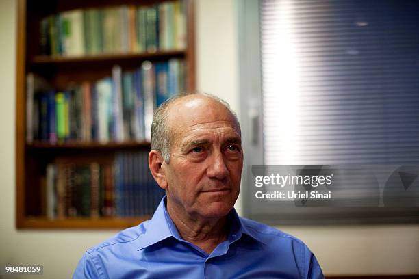 Former Israeli Prime Minister Ehud Olmert poses for photographers after delivering a public statement at his office on April 15, 2010 in Tel Aviv,...