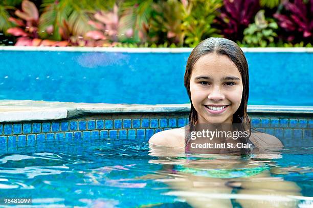 portrait of happy girl in swimming pool - inti st clair stock pictures, royalty-free photos & images