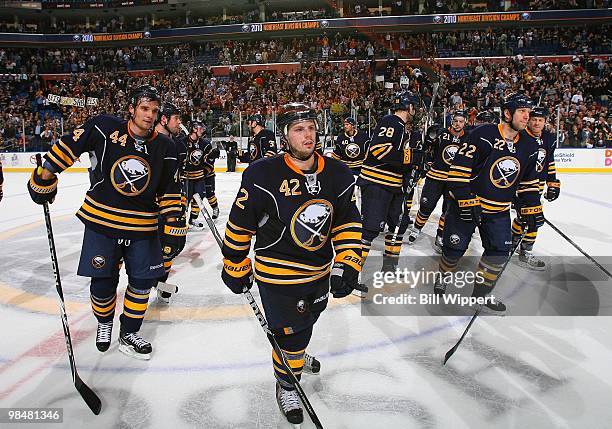 Andrej Sekera, Nathan Gerbe, and Adam Mair of the Buffalo Sabres salute the fans after defeating the New York Rangers on April 6, 2010 at HSBC Arena...