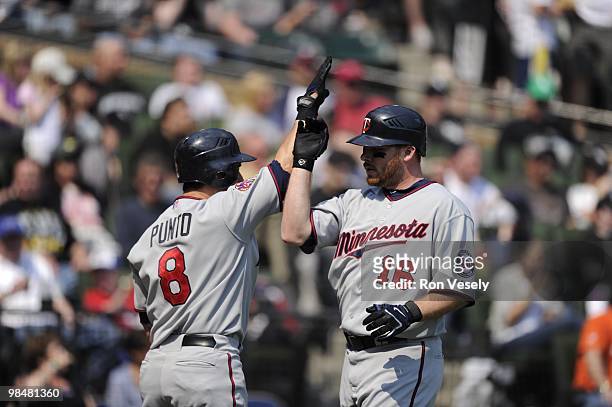 Jason Kubel of the Minnesota Twins celebrates with teammates after hitting a home run against the Chicago White Sox on April 10, 2010 at U.S....