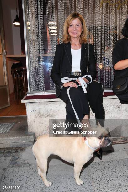 Johanna Fischer, mother of Delia Fischer with dog during the opening of the first "Krug Fischmarkt" pop up fish restaurant on June 26, 2018 in...