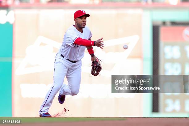 Texas Rangers Shortstop Elvis Andrus tosses a ball to begin a double play during the game between the San Diego Padres and Texas Rangers on June 26,...