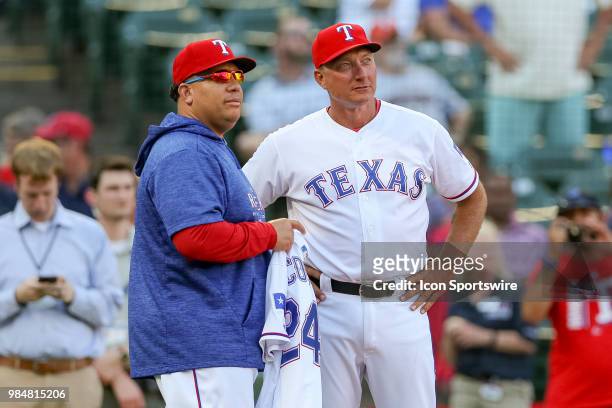 Texas Rangers Manager Jeff Bannister presents a jersey to Pitcher Bartolo Colon for becoming the all-time winning Dominican pitcher prior to the game...