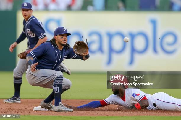 Texas Rangers Infield Jurickson Profar slides in under the tag of San Diego Padres Shortstop Freddy Galvis during the game between the San Diego...