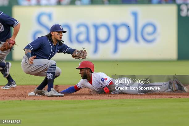 Texas Rangers Infield Jurickson Profar slides in under the tag of San Diego Padres Shortstop Freddy Galvis during the game between the San Diego...