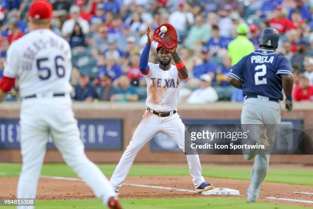 Texas Rangers Pitcher Austin Bibens-Dirkx throws over to Texas Rangers Infield Jurickson Profar on a ground ball by San Diego Padres Infield Jose...