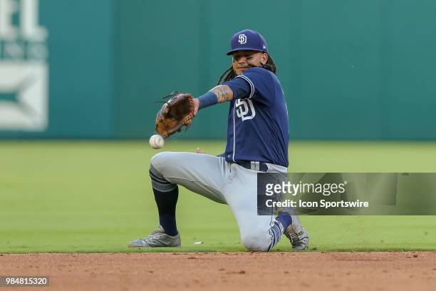San Diego Padres Shortstop Freddy Galvis attempts to field a hard hit ground ball that turns into a hit during the game between the San Diego Padres...