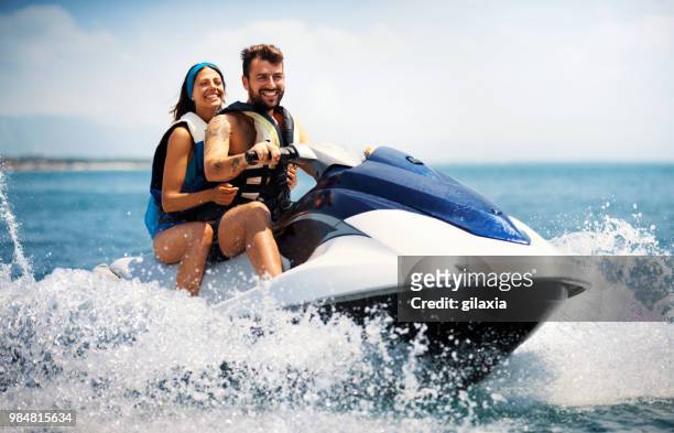 jet skiing. - life jacket stock pictures, royalty-free photos & images