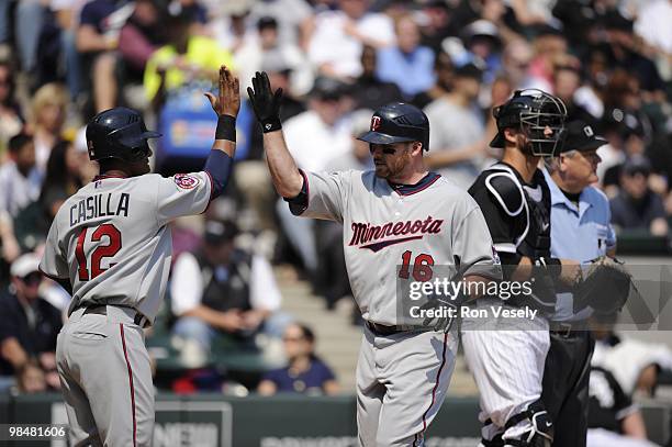 Jason Kubel of the Minnesota Twins celebrates with teammates after hitting a home run against the Chicago White Sox on April 10, 2010 at U.S....