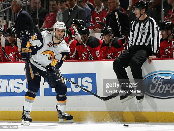 Paul Gaustad of the Buffalo Sabres plays the puck against the New Jersey Devils during the game at the Prudential Center on April 11, 2010 in Newark,...