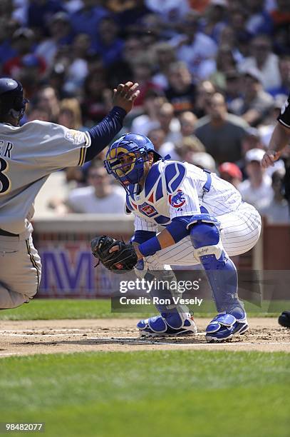 Geovany Soto of the Chicago Cubs prepares to tag out Prince Fielder of the Milwaukee Brewers at home plate on April 14, 2010 at Wrigley Field in...