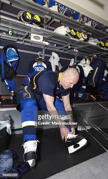Keith Tkachuk of the St. Louis Blues laces his skates prior the last home game of his career against the Anaheim Ducks on April 9, 2010 at Scottrade...