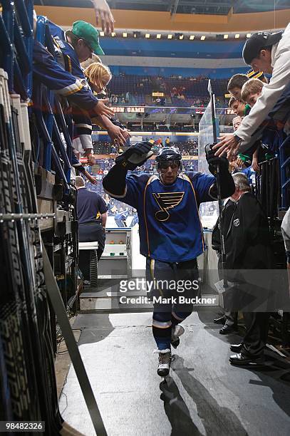 David Perron of the St. Louis Blues walks off the ice and high fives fans after warm ups before a game against the Anaheim Ducks on April 9, 2010 at...