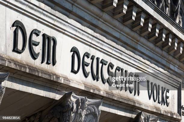 the famous inscription on the architrave on the west portal of the reichstag building in berlin: "dem deutschen volke" (germany) - architrave stock pictures, royalty-free photos & images