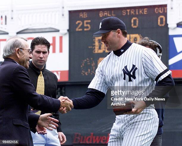 New York Yankees' pitcher Roger Clemens receives his 1999 World Series Championship ring and is congratulated by Yogi Berra during pregame ceremonies...