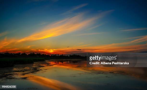 sunset over crystal lake - albena stock-fotos und bilder