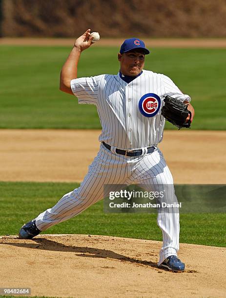 Starting pitcher Carlos Zambrano of the Chicago Cubs, wearing a number 42 jersey in honor of Jackie Robinson, delivers the ball against the Milwaukee...