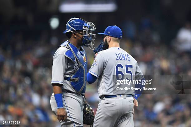 Jakob Junis of the Kansas City Royals speaks with Salvador Perez during the fifth inning of a game against the Milwaukee Brewers at Miller Park on...