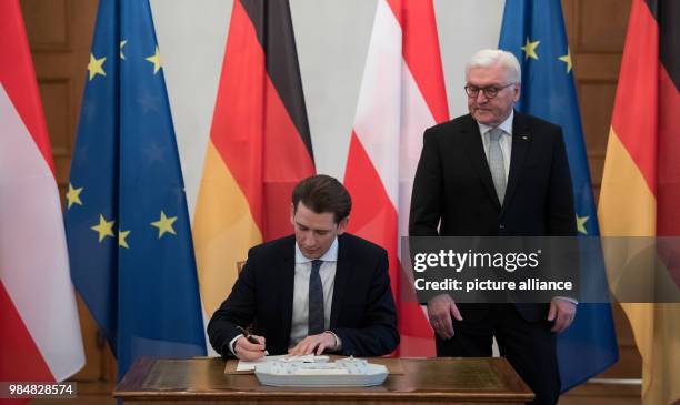 German president Frank-Walter Steinmeier watches as Austrian chancellor Sebastian Kurz signs the golden book at Bellevue Palace in Berlin, Germany,...