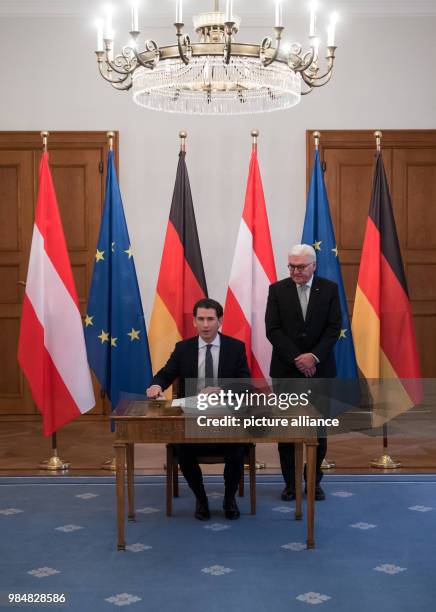 German president Frank-Walter Steinmeier watches as Austrian chancellor Sebastian Kurz signs the golden book at Bellevue Palace in Berlin, Germany,...