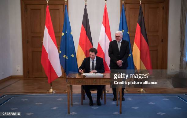 German president Frank-Walter Steinmeier watches as Austrian chancellor Sebastian Kurz signs the golden book at Bellevue Palace in Berlin, Germany,...