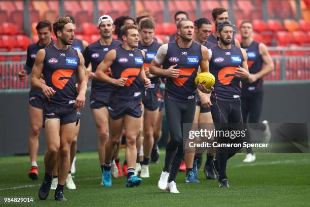 Sam Reid of the Giants warms up with team mates during a Greater Western Sydney Giants AFL training session at Spotless Stadium on June 27, 2018 in...