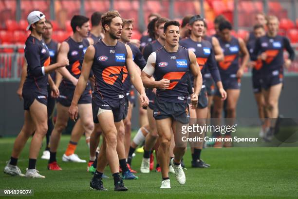Dylan Shiel of the Giants and team mates warm up during a Greater Western Sydney Giants AFL training session at Spotless Stadium on June 27, 2018 in...