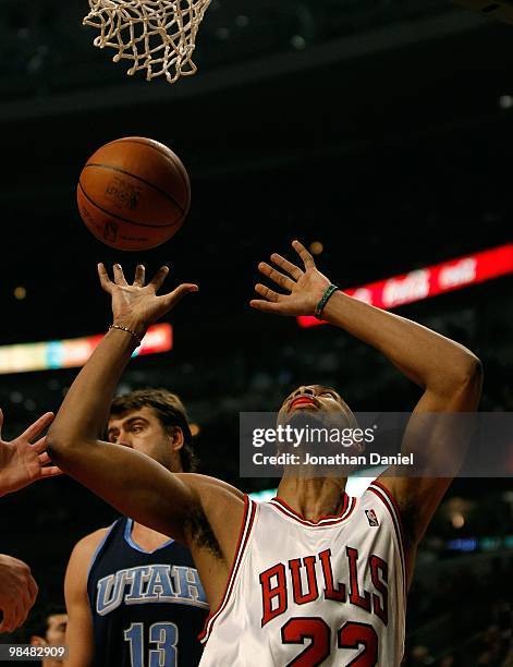 Taj Gibson of the Chicago Bulls grabs the ball in front of Mehmet Okur of the Utah Jazz at the United Center on March 9, 2010 in Chicago, Illinois....