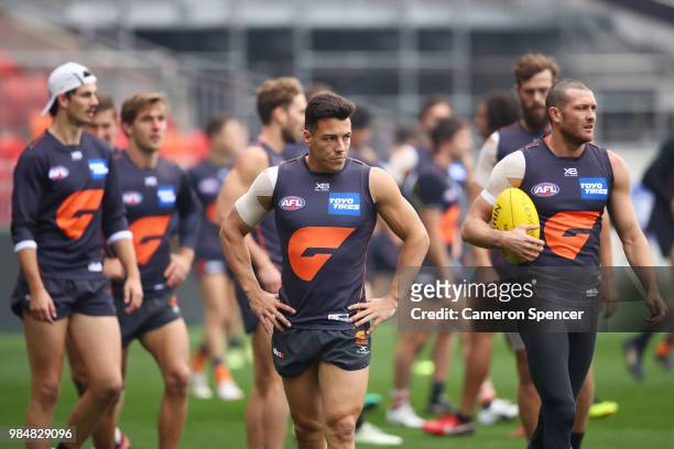 Dylan Shiel of the Giants and team mates warm up during a Greater Western Sydney Giants AFL training session at Spotless Stadium on June 27, 2018 in...