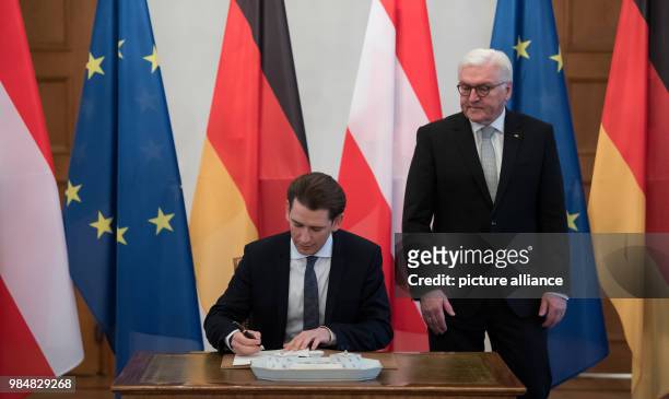 Dpatop - German President Frank-Walter Steinmeier watches Austrian Chancellor Sebastian Kurz as he signs the guest book at the Bellevue Palace in...