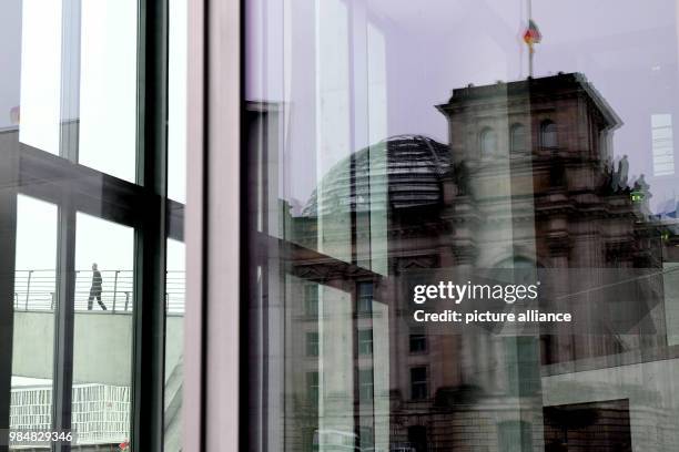 The German Reichstag is reflected in the facade of the Marie Elisabeth Lueders House in Berlin, Germany, 18 January 2018. German weather service has...