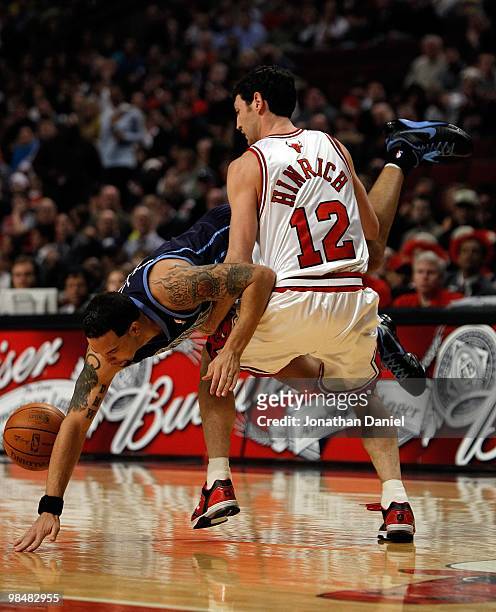 Deron Williams of the Utah Jazz flips in the air and looses the ball as he is fouled by Kirk Hinrich of the Chicago Bulls at the United Center on...