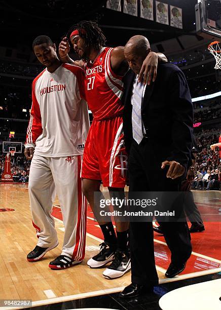 Jordan Hill of the Houston Rockets is helped off the court after injuring his leg against the Chicago Bulls at the United Center on March 22, 2010 in...