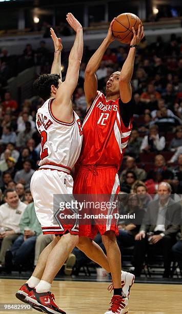 Kevin Martin of the Houston Rockets puts up a shot and is fouled by Kirk Hinrich of the Chicago Bulls at the United Center on March 22, 2010 in...