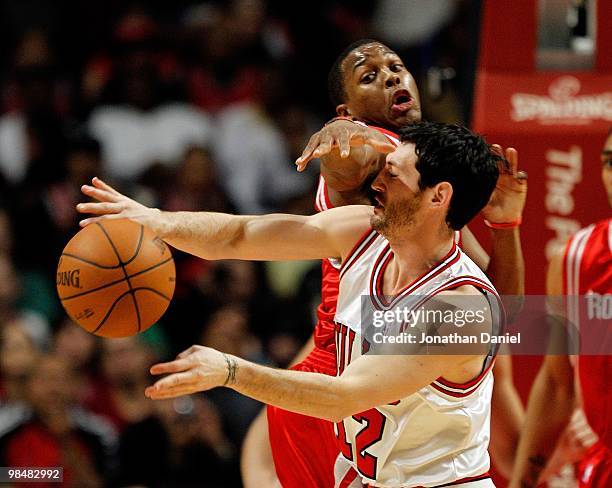Kirk Hinrich of the Chicago Bulls is hit in the face while passing by Kyle Lowry of the Houston Rockets at the United Center on March 22, 2010 in...