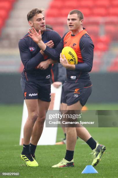 Stephen Coniglio of the Giants and Heath Shaw of the Giants interact during a Greater Western Sydney Giants AFL training session at Spotless Stadium...