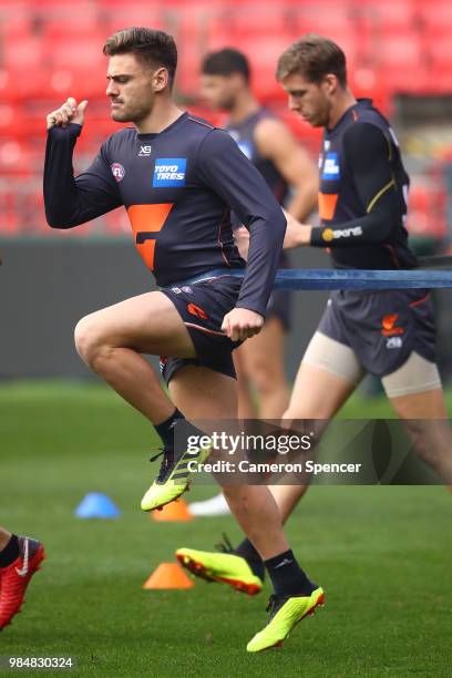 Stephen Coniglio of the Giants warms up during a Greater Western Sydney Giants AFL training session at Spotless Stadium on June 27, 2018 in Sydney,...