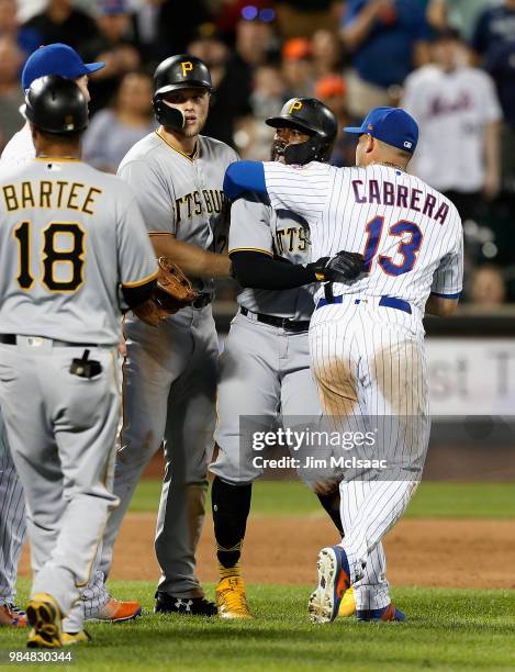 Asdrubal Cabrera of the New York Mets and Austin Meadows of the Pittsburgh Pirates hold back Josh Harrison of Pittsburgh as the benches clear during...