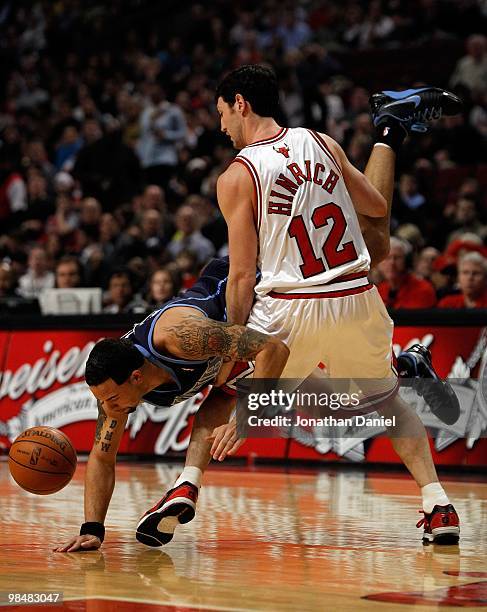 Deron Williams of the Utah Jazz flips in the air and looses the ball as he is fouled by Kirk Hinrich of the Chicago Bulls at the United Center on...