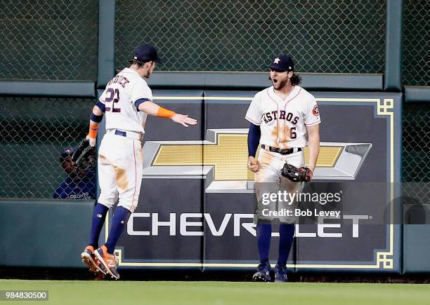 Jake Marisnick of the Houston Astros celebrates with Josh Reddick after making a catch at the wall by Justin Smoak of the Toronto Blue Jays at Minute...