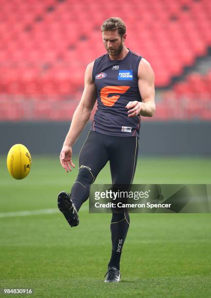 Dawson Simpson of the Giants kicks during a Greater Western Sydney Giants AFL training session at Spotless Stadium on June 27, 2018 in Sydney,...