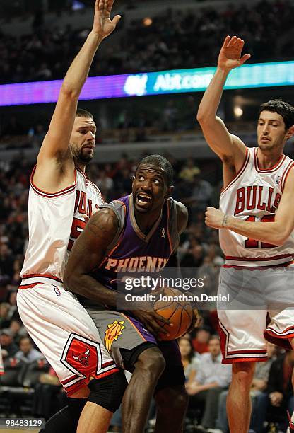 Jason Richardson of the Phoenix Suns looks to shoot between Brad Miller and Kirk Hinrich of the Chicago Bulls at the United Center on March 30, 2010...