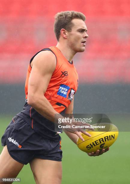 Zac Langdon of the Giants runs the ball during a Greater Western Sydney Giants AFL training session at Spotless Stadium on June 27, 2018 in Sydney,...