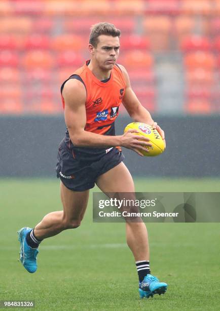 Zac Langdon of the Giants runs the ball during a Greater Western Sydney Giants AFL training session at Spotless Stadium on June 27, 2018 in Sydney,...