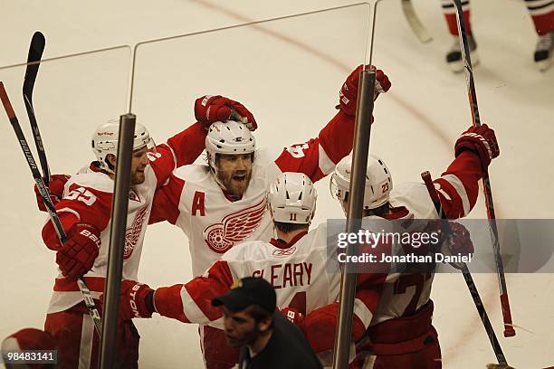 Niklas Kronwall and Henrik Zetterberg of the Detroit Red Wings celebrate the winning goal against the Chicago Blackhawks by teammate Brad Stuart at...