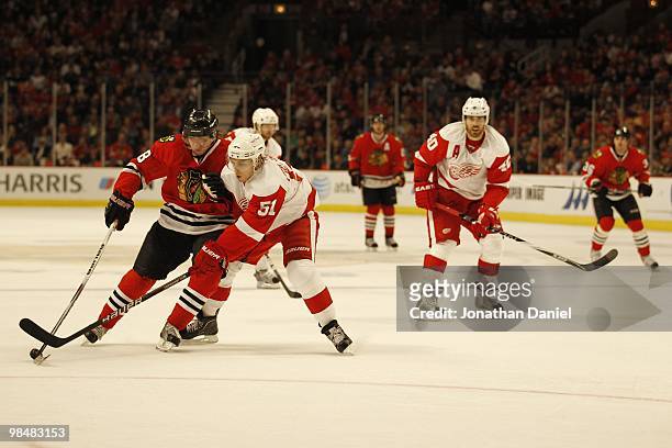 Patrick Kane of the Chicago Blackhawks tries to control the puck against Valtteri Filppula of the Detroit Red Wings applies defensive pressure at the...