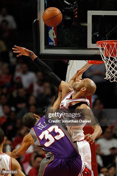 Taj Gibson of the Chicago Bulls attempts to block a shot by Grant Hill of the Phoenix Suns at the United Center on March 30, 2010 in Chicago,...